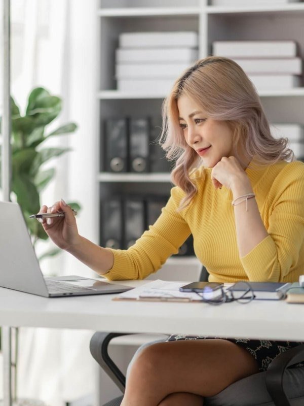 Business professional managing tasks remotely at a desk