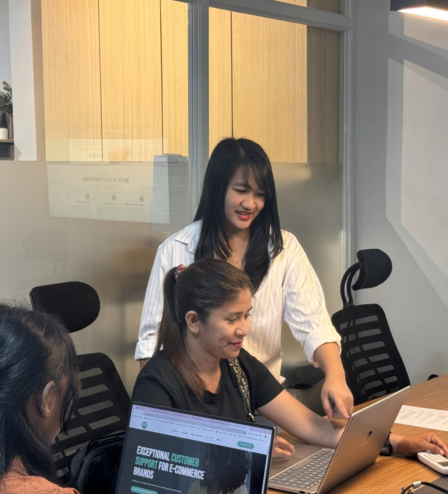 JVAS team collaborating around a computer
