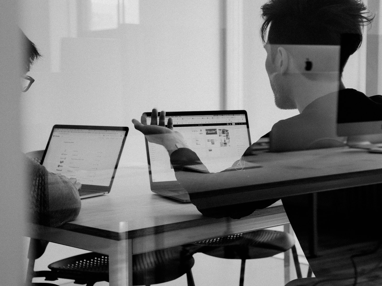 Professionals reviewing business dashboards on a laptop