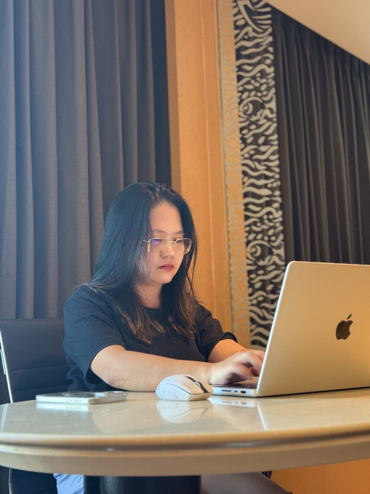 Jean Aguilar, founder of JVAS, working on a laptop
